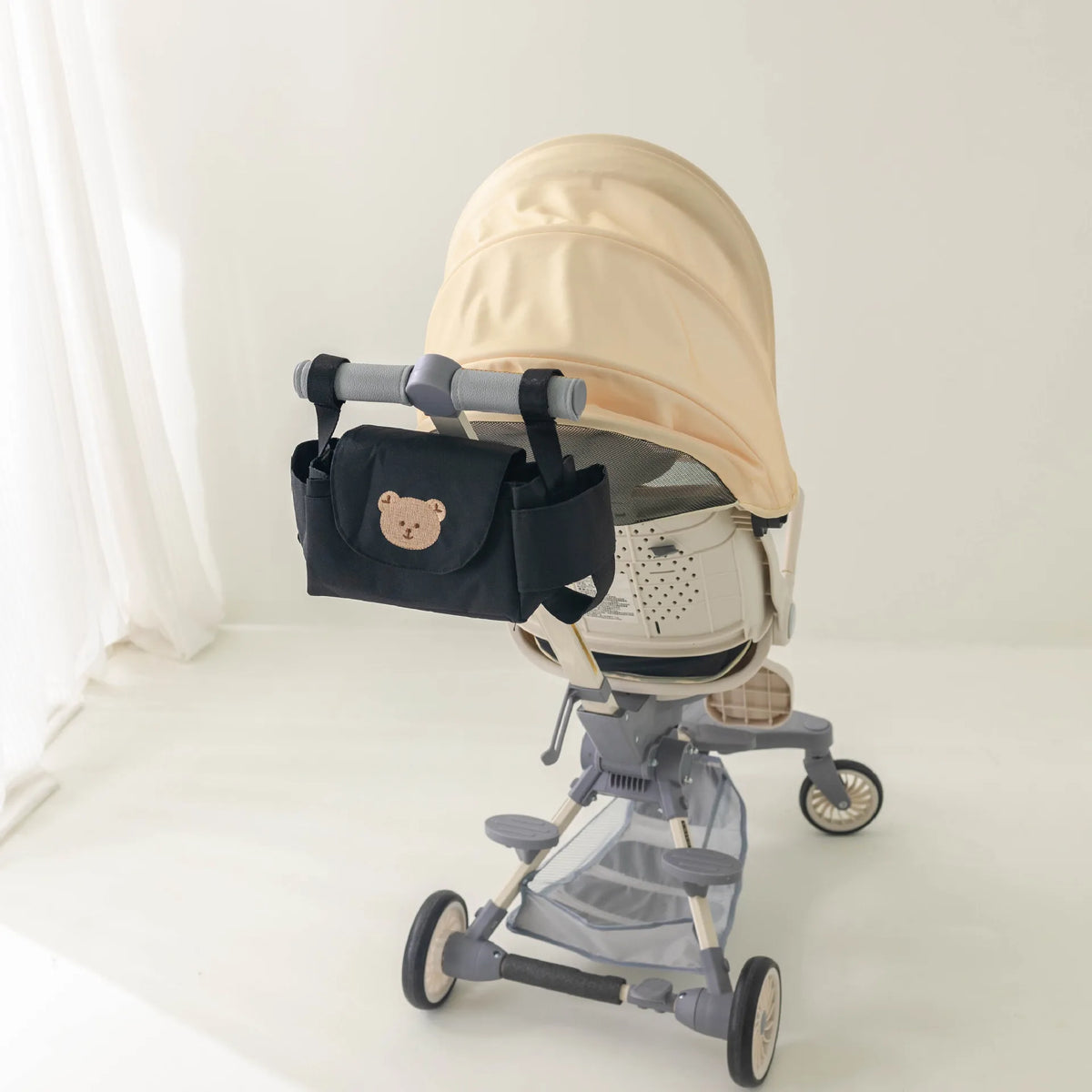 Black stroller organizer bag on a full stroller