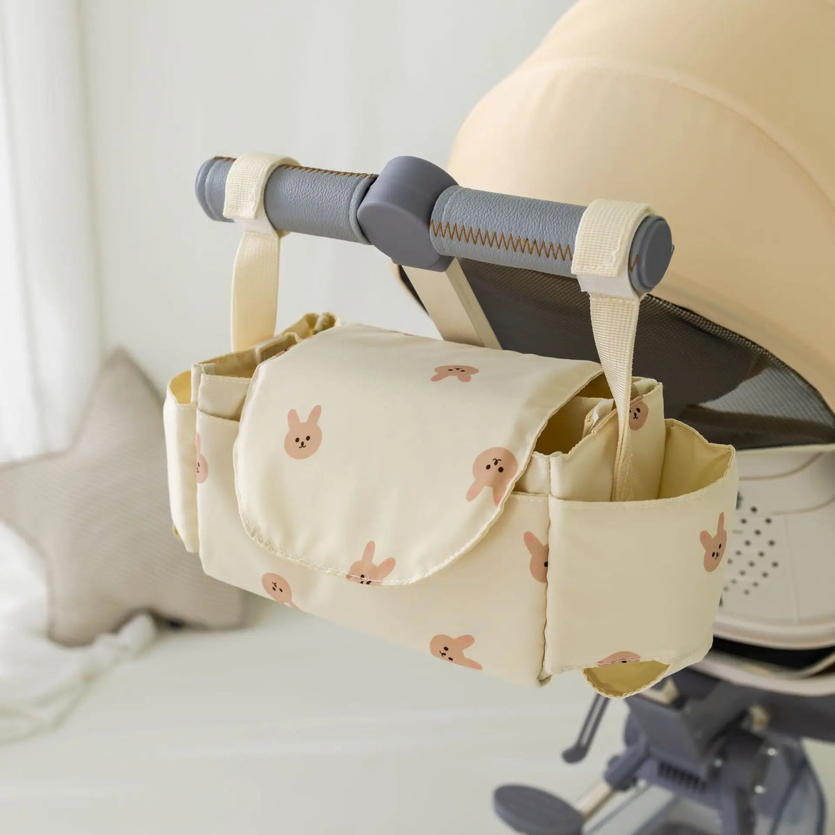 Beige rabbit stroller organizer bag on a pram