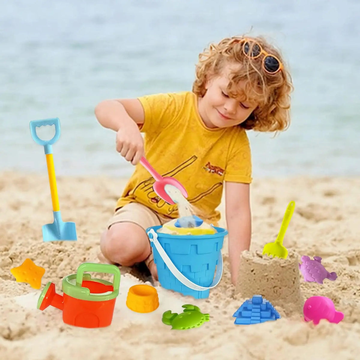 Child playing with the beach sand toy set at the beach