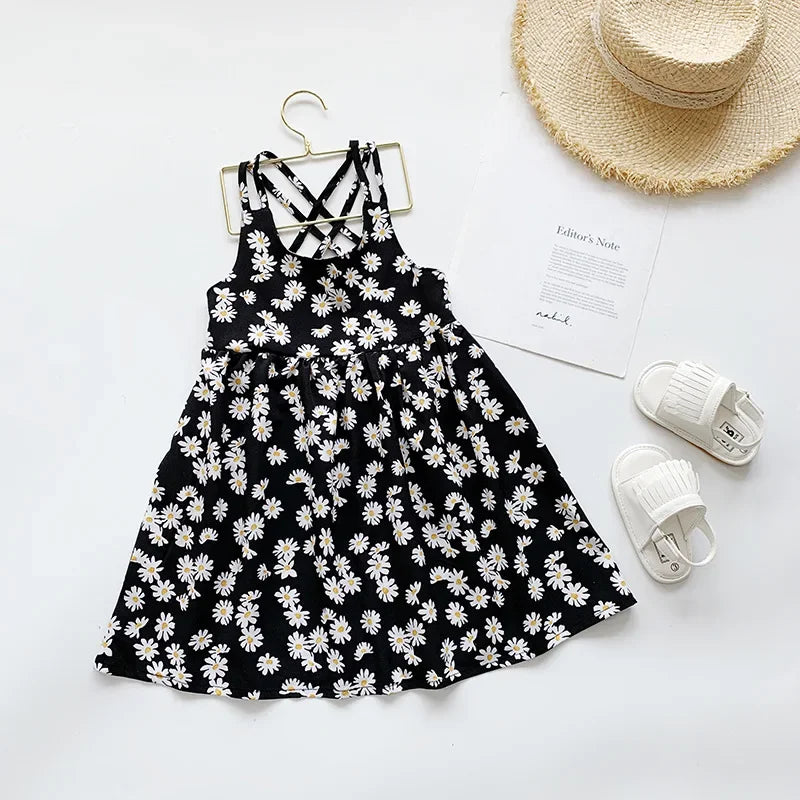 Black daisy print slip dress with cross-back straps